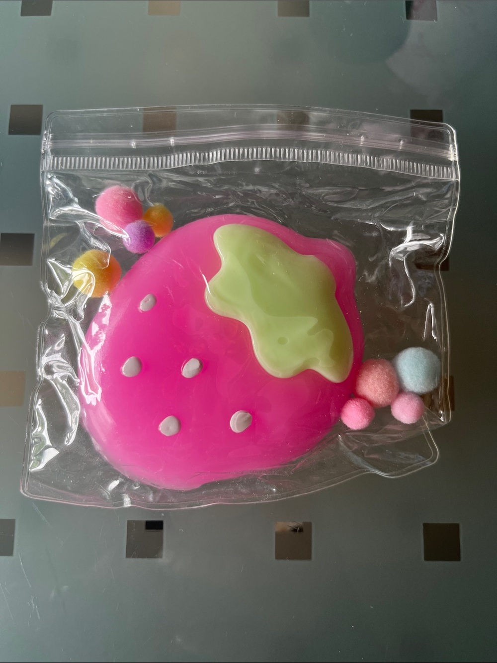 Pink Strawberry Squishy with Pom Pom accents.